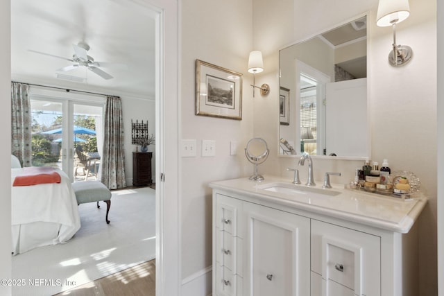 bathroom featuring vanity, crown molding, and ceiling fan