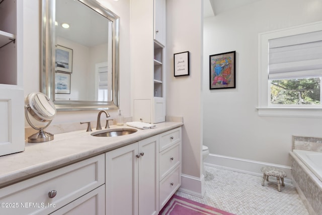 bathroom with vanity, tiled tub, tile patterned flooring, and toilet