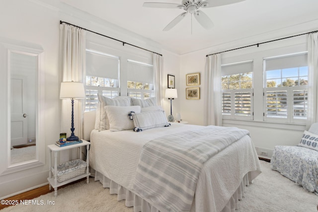 bedroom featuring crown molding, ceiling fan, and light hardwood / wood-style floors