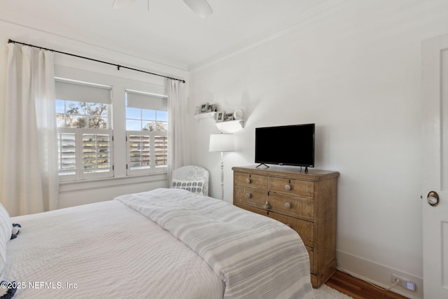 bedroom with hardwood / wood-style flooring, ceiling fan, and ornamental molding