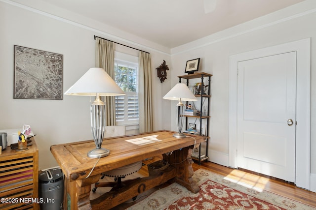 office area featuring wood-type flooring and ornamental molding