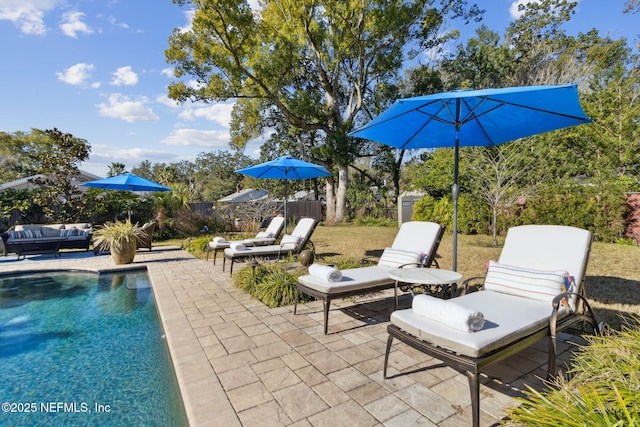 view of patio featuring a fenced in pool and an outdoor hangout area