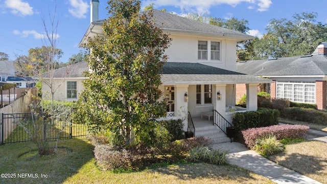 view of front of house with a porch and a front lawn