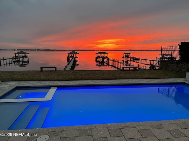 pool at dusk with a water view