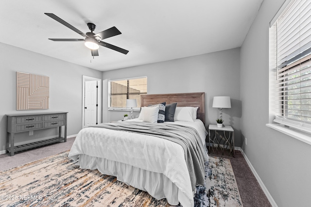 bedroom featuring multiple windows, carpet flooring, and ceiling fan