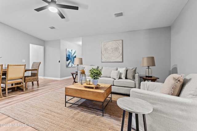 living room with hardwood / wood-style floors and ceiling fan