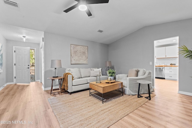 living room with light hardwood / wood-style flooring, ceiling fan, and vaulted ceiling