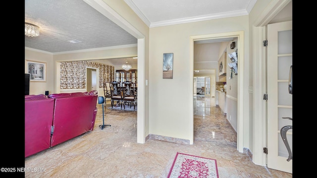 entryway with crown molding and a textured ceiling