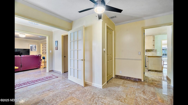 hall featuring ornamental molding and a textured ceiling