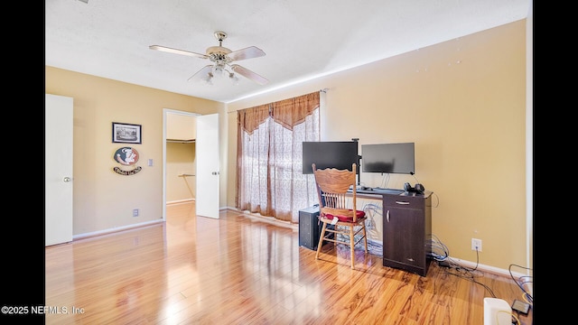 home office featuring ceiling fan and light wood-type flooring