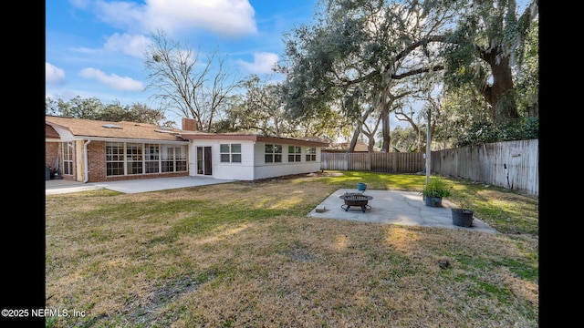 view of yard with a fire pit and a patio area