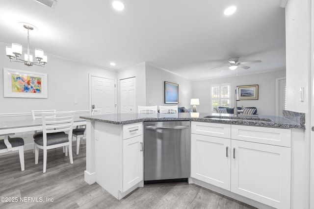 kitchen with white cabinetry, hanging light fixtures, crown molding, and stainless steel dishwasher