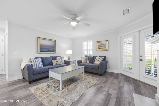 living room with ornamental molding, hardwood / wood-style floors, ceiling fan, and french doors