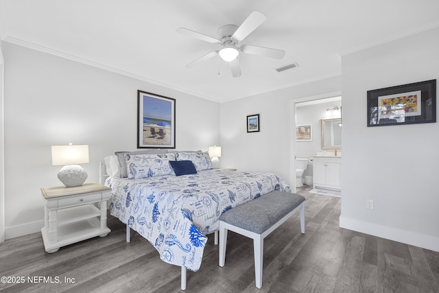 bedroom featuring ornamental molding, ceiling fan, dark hardwood / wood-style flooring, and ensuite bath