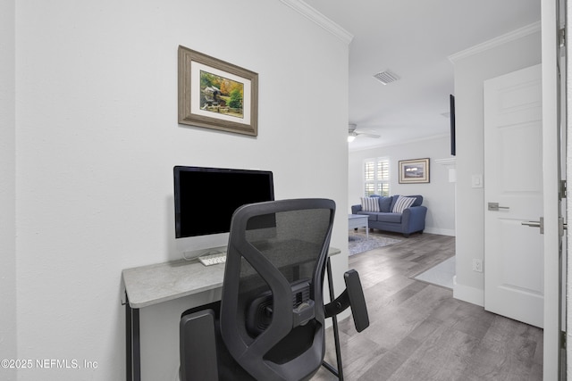 home office featuring crown molding, wood-type flooring, and ceiling fan