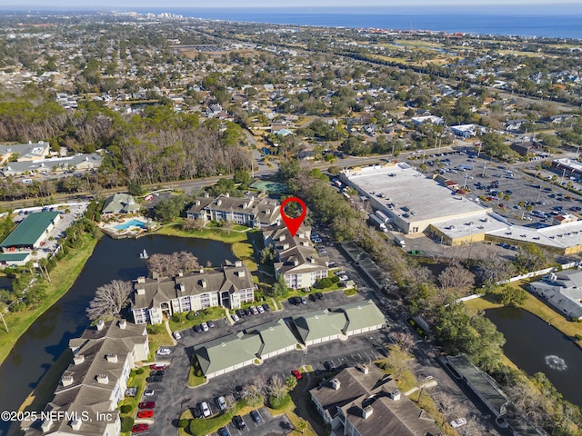 birds eye view of property with a water view