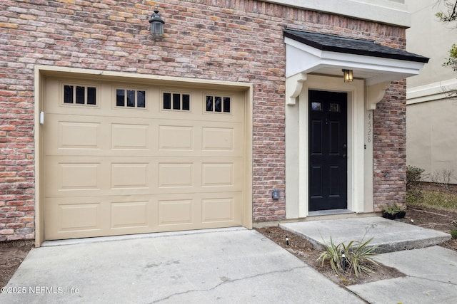 doorway to property with a garage