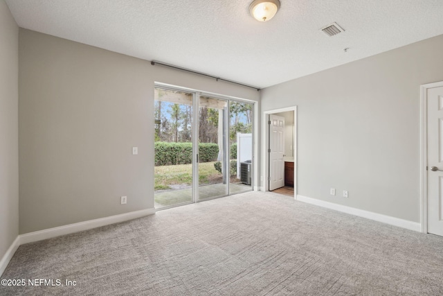 carpeted spare room with a textured ceiling