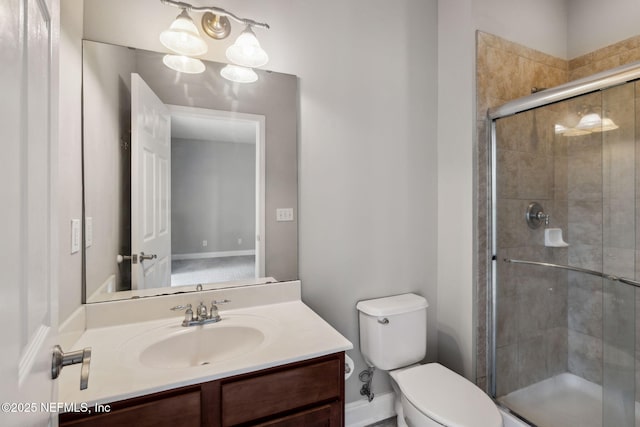 bathroom featuring vanity, an enclosed shower, and toilet