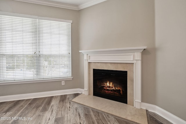 room details featuring crown molding, hardwood / wood-style flooring, and a high end fireplace