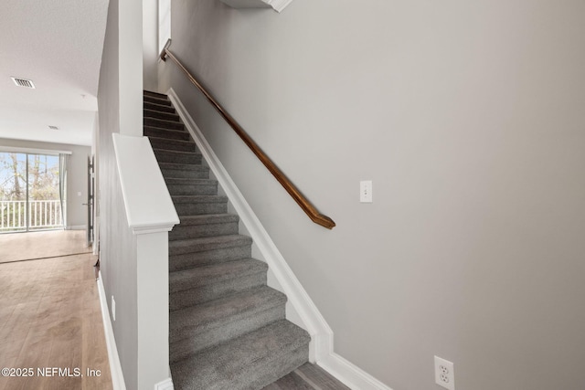 stairway featuring wood-type flooring