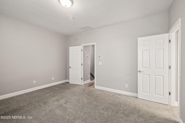 unfurnished bedroom featuring carpet flooring and a textured ceiling