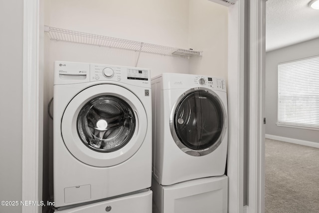 laundry room featuring carpet and washer and dryer