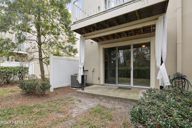 doorway to property with central AC and a patio area