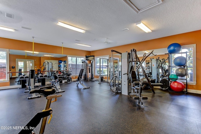 workout area featuring a textured ceiling