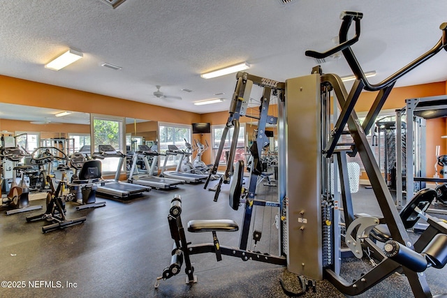 gym featuring a textured ceiling