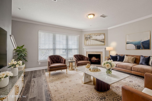 living room featuring crown molding, hardwood / wood-style floors, and a textured ceiling