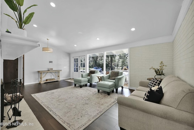 living room with french doors, brick wall, dark hardwood / wood-style flooring, and vaulted ceiling