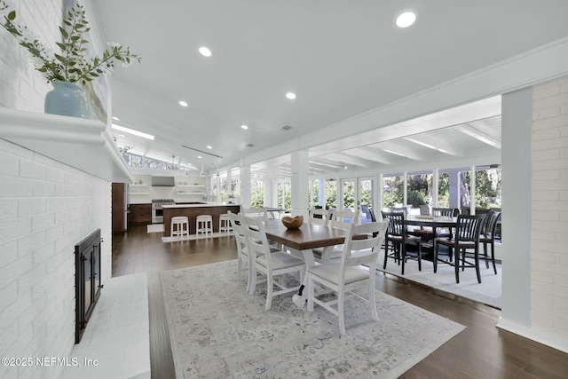 dining space with vaulted ceiling and dark hardwood / wood-style floors