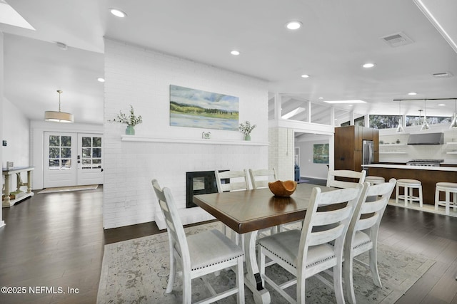 dining space with dark hardwood / wood-style flooring and french doors