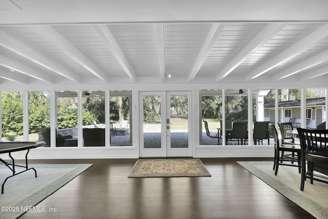 sunroom with beam ceiling and french doors