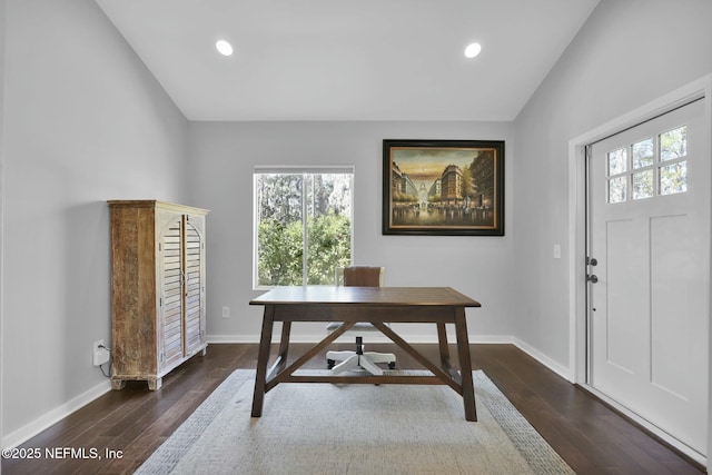 home office with lofted ceiling and dark wood-type flooring