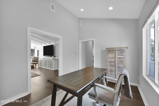 office with vaulted ceiling and dark wood-type flooring