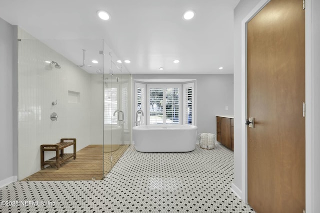 bathroom featuring vanity and separate shower and tub