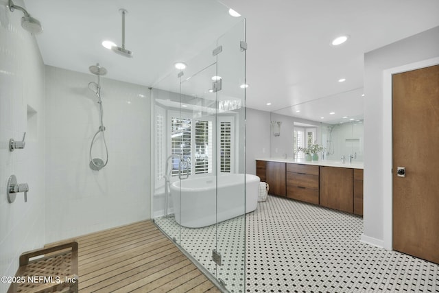 bathroom featuring vanity and separate shower and tub