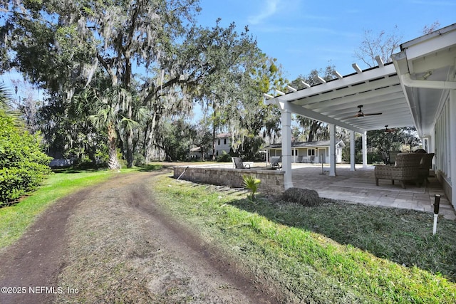 view of yard with a patio, an outdoor hangout area, and ceiling fan