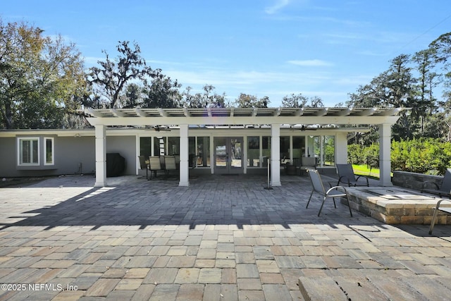 rear view of house with a pergola and a patio