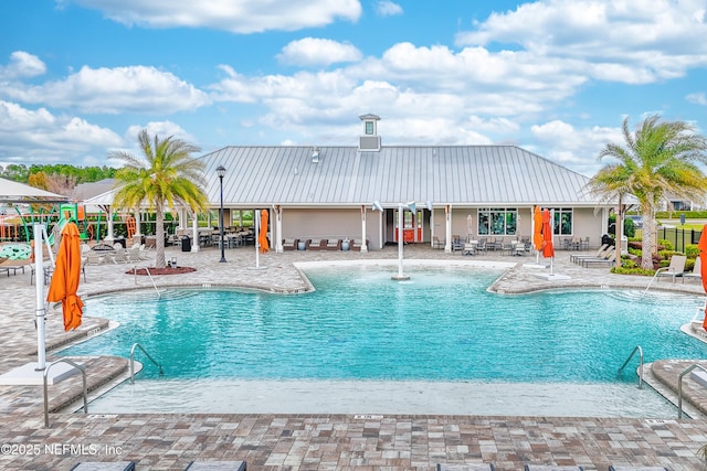 view of swimming pool with a patio area and pool water feature