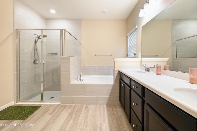 bathroom featuring plus walk in shower and vanity