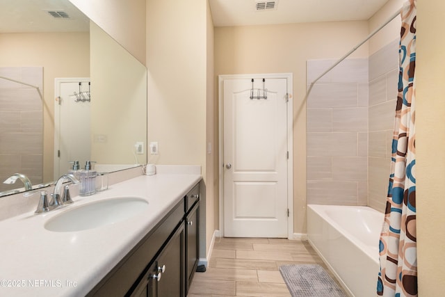 bathroom with vanity and shower / tub combo with curtain