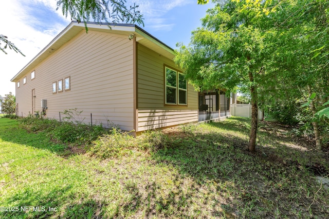 view of side of property featuring a yard