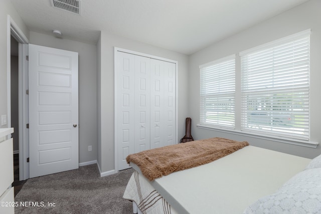 carpeted bedroom with a closet