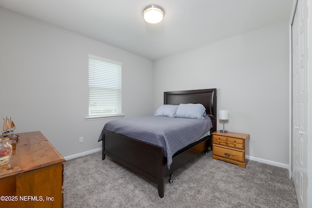 bedroom with a closet and light carpet