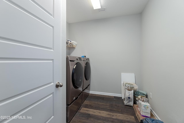 washroom featuring dark hardwood / wood-style flooring and independent washer and dryer