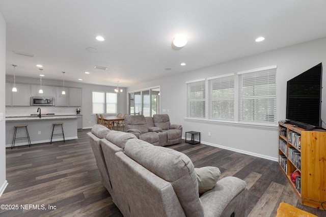 living room with sink and dark wood-type flooring