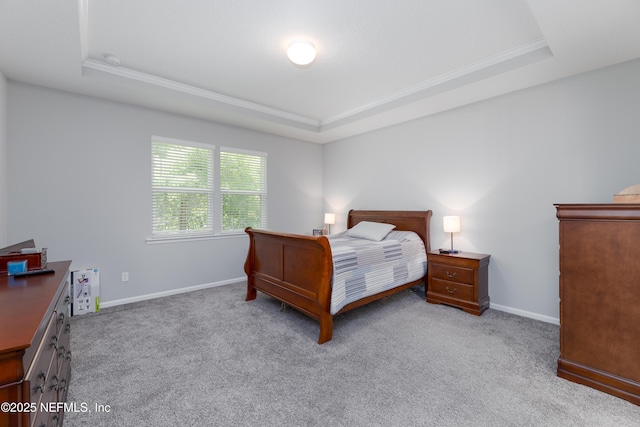 bedroom featuring ornamental molding, light colored carpet, and a raised ceiling